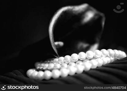 Pearl necklace and black calla flower close-up