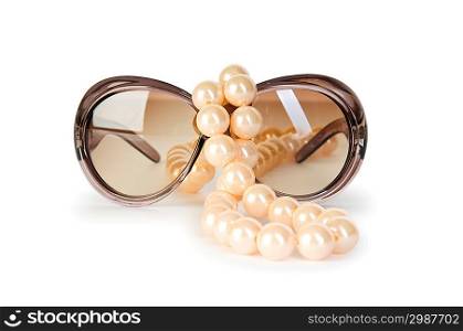 Pearl necklace and sunglasses isolated on the white background