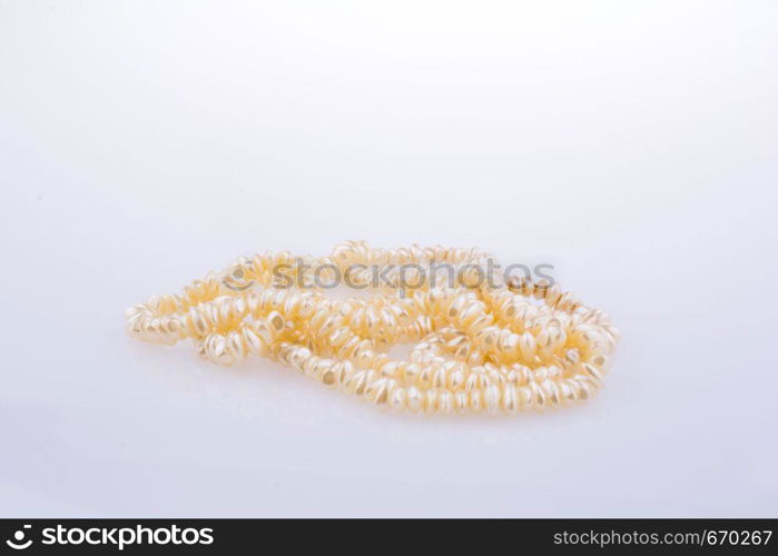 pearl necklace is placed on white background