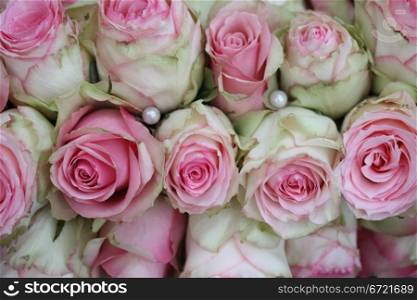 Pearls and pink/white roses in a bridal bouquet