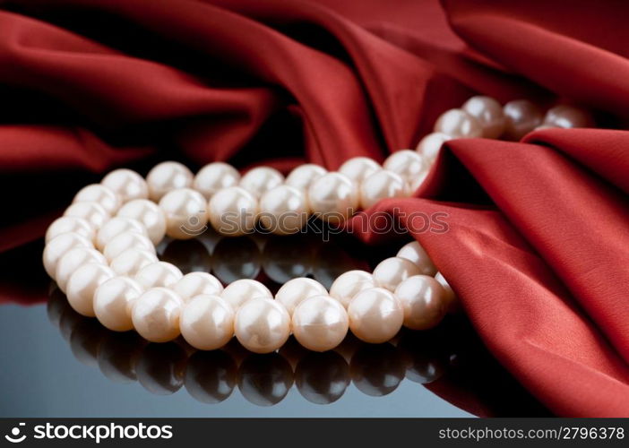 Pearls necklace on satin background