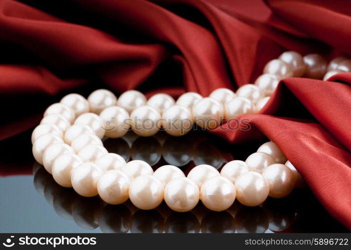 Pearls necklace on satin background