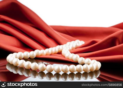 Pearls necklace on satin background