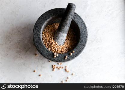 peas with a ceramic mortar for grinding close-up on a white background, selective focus.. peas with a ceramic mortar for grinding close-up on a white background, selective focus