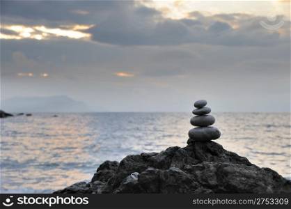 Pebble and stones on a background of the drama sky. Coast of the black sea Crimea, Ukraine