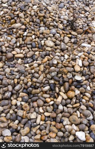 Pebbles can be used as a background, stones are on a UK beach.
