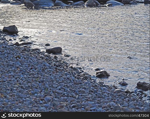 pebbles on the shore of the lake