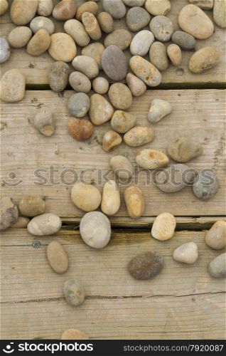 Pebbles scattered over wooden planks