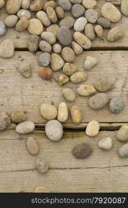 Pebbles scattered over wooden planks