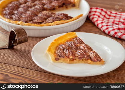 Pecan pie - traditional southern US dessert on wooden table