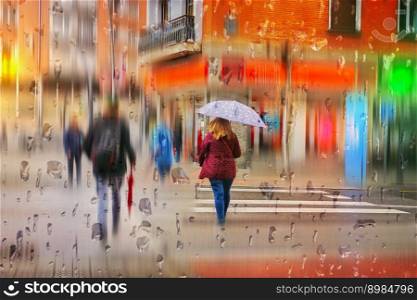  pedestian with an umbrella in rainy days in Bilbao city, spain