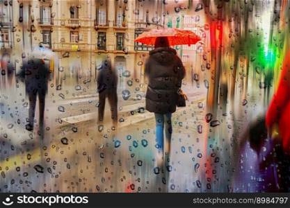 pedestian with an umbrella in rainy days in Bilbao city, spain