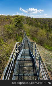 pedestrian bridge in the mountains. Metal pedestrian bridge in the mountains