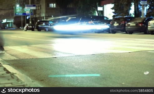 pedestrian crossing on the streets of the city at night. timelapse.