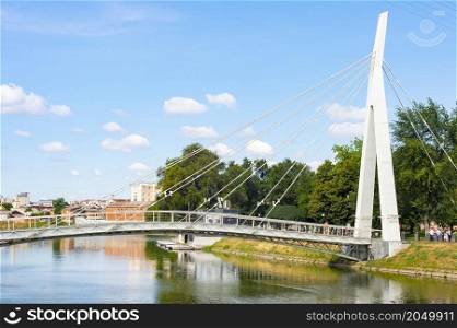 Pedestrian Mariinsky Bridge over Lopan river, sunshine, summer view Kharkiv, Ukraine