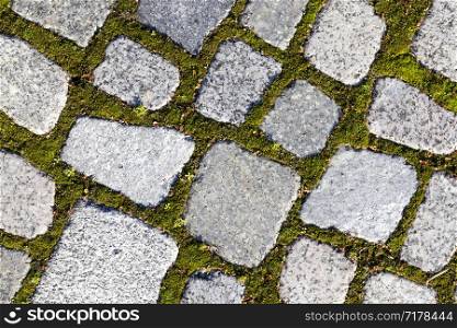 pedestrian road built of tiles and stones with cobblestones, close-up of a part of the roadway. pedestrian road