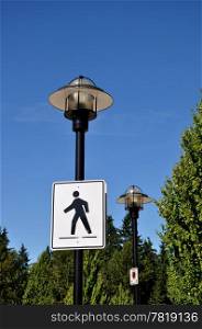 Pedestrian road sign with road lamp