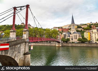 Pedestrian Saint Georges footbridge and the Saint Georges church in Lyon, France in a beautiful summer day