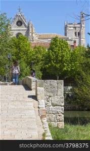 Pedestrian stone bridge, with church in the background in the town of Palencia, Spain