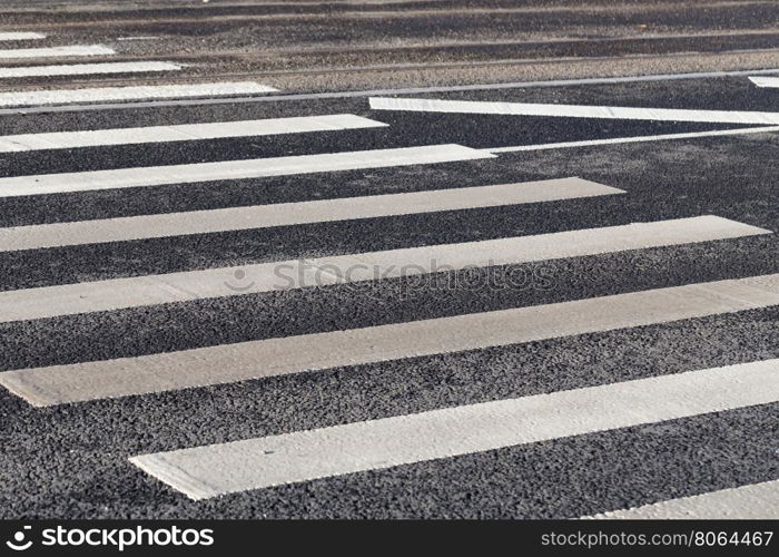 Pedestrian zebra crossing white stripes on the road
