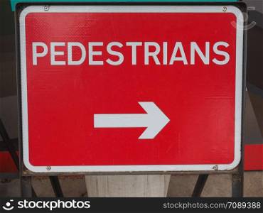 pedestrians direction sign in white over red. pedestrians road sign