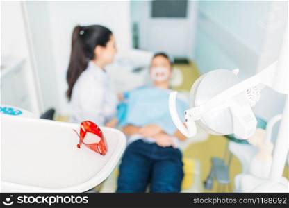 Pediatric dentistry concept, children stomatology. Female dentist examines the teeth of a small patient. Pediatric dentistry concept, children stomatology