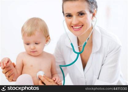 Pediatric doctor examine kid using stethoscope