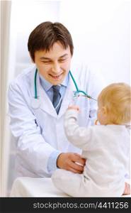Pediatric doctor trying to examine baby &#xA;