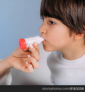 Pediatric pulmonologist helping little boy with aero inhaler. Pulmonologist, medical doctor who specializes in the diagnosis and treatment of diseases and disorders of respiratory system, lungs, bronchial tubes, trachea and structures involving in breathing.. Pediatric Pulmonology, Pulmonologist Helping Little Boy with Inhaler