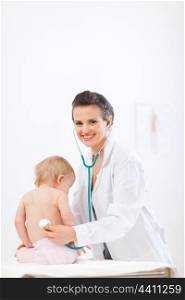 Pediatrician doctor examine baby using stethoscope