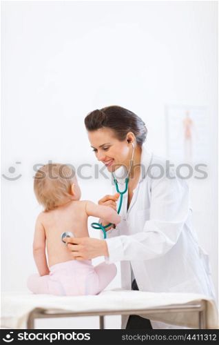 Pediatrician doctor examine kid using stethoscope