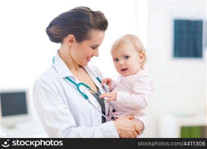 Pediatrician doctor with baby on examination