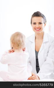 Pediatrician doctor with baby on survey