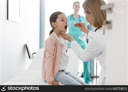 Pediatrician examining girl at hospital