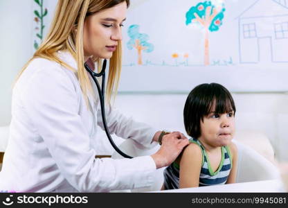 Pediatrician examining little boy with stethoscope