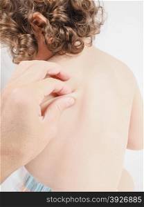 Pediatrician having health check on unrecognizable child with squeeze massage on back