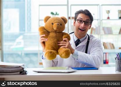 Pediatrician with toy sitting in the office. The pediatrician with toy sitting in the office