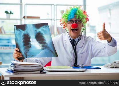 Pediatrician with x-ray image sitting in the office