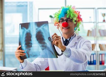 Pediatrician with x-ray image sitting in the office. The pediatrician with x-ray image sitting in the office