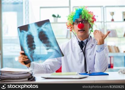 Pediatrician with x-ray image sitting in the office. The pediatrician with x-ray image sitting in the office