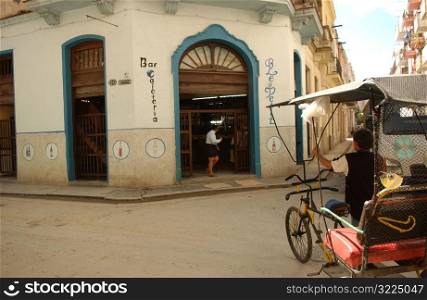Pedicab parked front of a building structure, Havana, Cuba