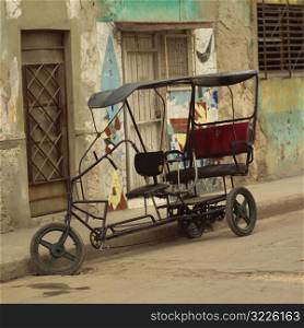 pedicab parked on the side of a street, Havana, Cuba