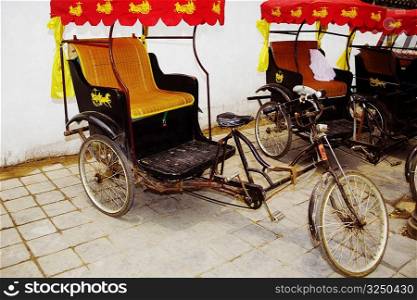 Pedicabs in front of a wall, Qufu, Shandong Province, China