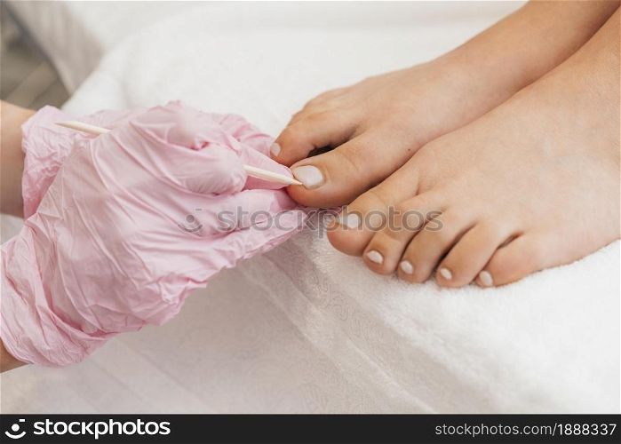 pedicurist wearing protection gloves feet . Resolution and high quality beautiful photo. pedicurist wearing protection gloves feet . High quality and resolution beautiful photo concept
