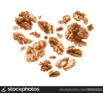 Peeled from the shell, walnut kernels in the shape of a heart on a white background.. Peeled from the shell, walnut kernels in the shape of a heart