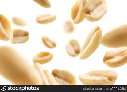 Peeled peanuts levitate on a white background.. Peeled peanuts levitate on a white background