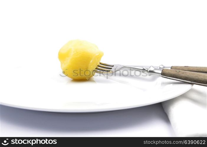 Peeled potato on table