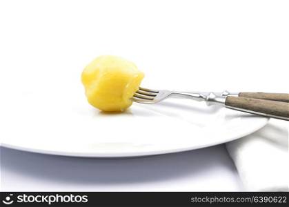 Peeled potato on table