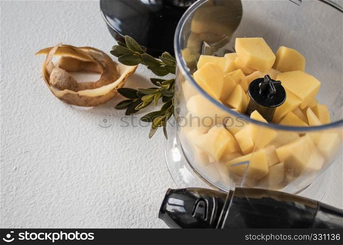 Peeled potatoes and cut into cubes, pieces. The process of cooking. Natural Potatoes. Peeled potatoes and diced. Cooking.
