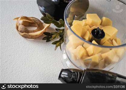 Peeled potatoes and cut into cubes, pieces. The process of cooking. Natural Potatoes. Peeled potatoes and diced. Cooking.